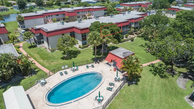 an aerial view of a house with a garden and swimming pool