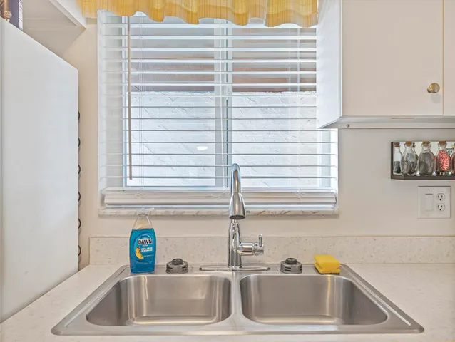 a bathroom with a sink and a window