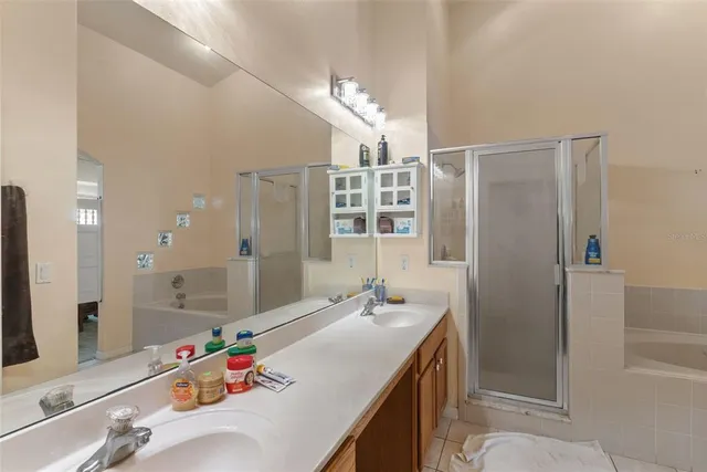 a bathroom with a tub sink and mirror