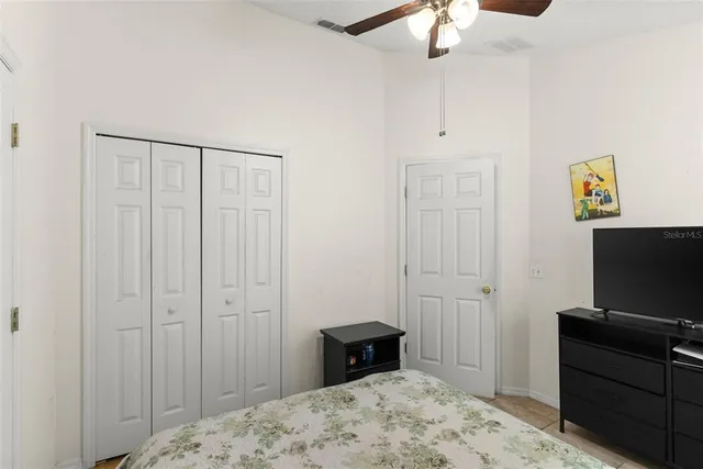 a bedroom with a bed and a mirror on dresser