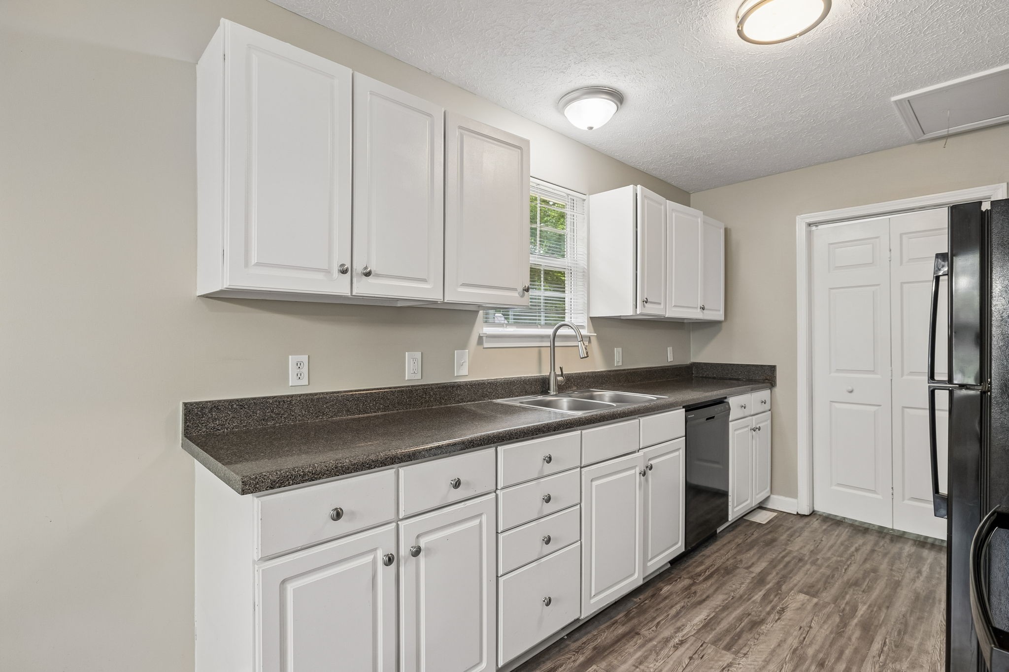 511 Hayes Street Springfield, TN 37172 - Photo 10 of 26 a kitchen with granite countertop a sink stainless steel appliances white cabinets and a window