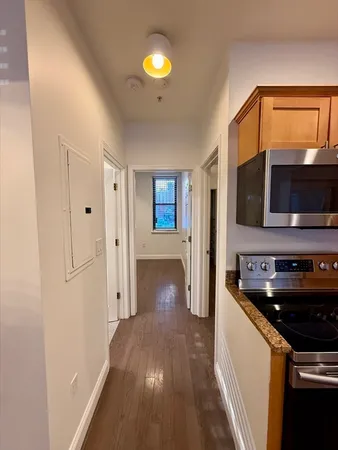 a view of a kitchen from the hallway