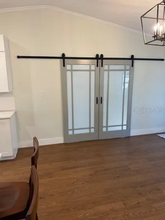 a view of a room with wooden floor and fan