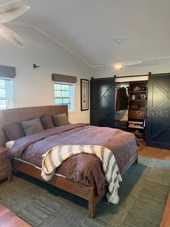 a bedroom with a bed and a television