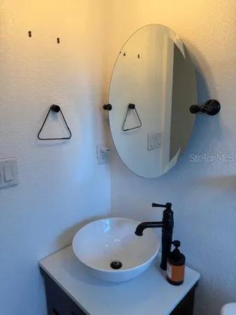 a bathroom with a sink and mirror