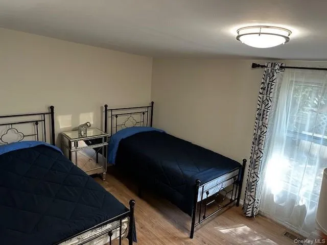 a bedroom with a bed and a chair