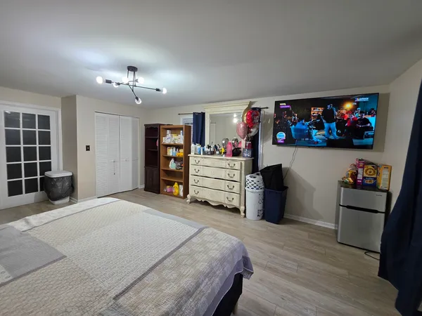 a bed room with a bed and a television