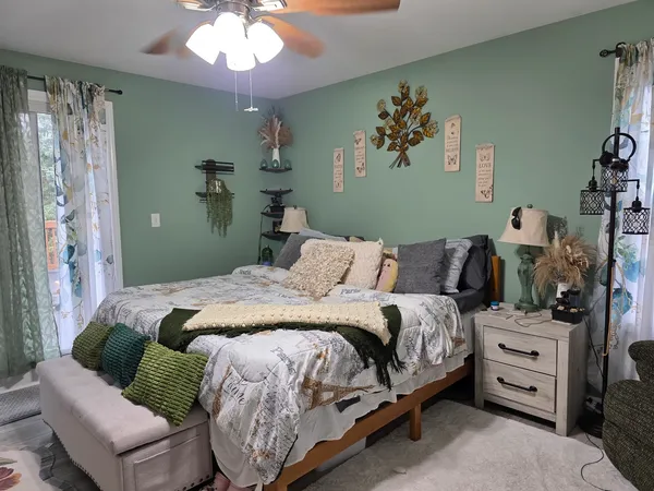 a bedroom with a bed and a chandelier