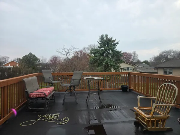 a view of a roof deck with furniture