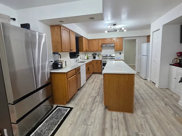 a large kitchen with cabinets and stainless steel appliances