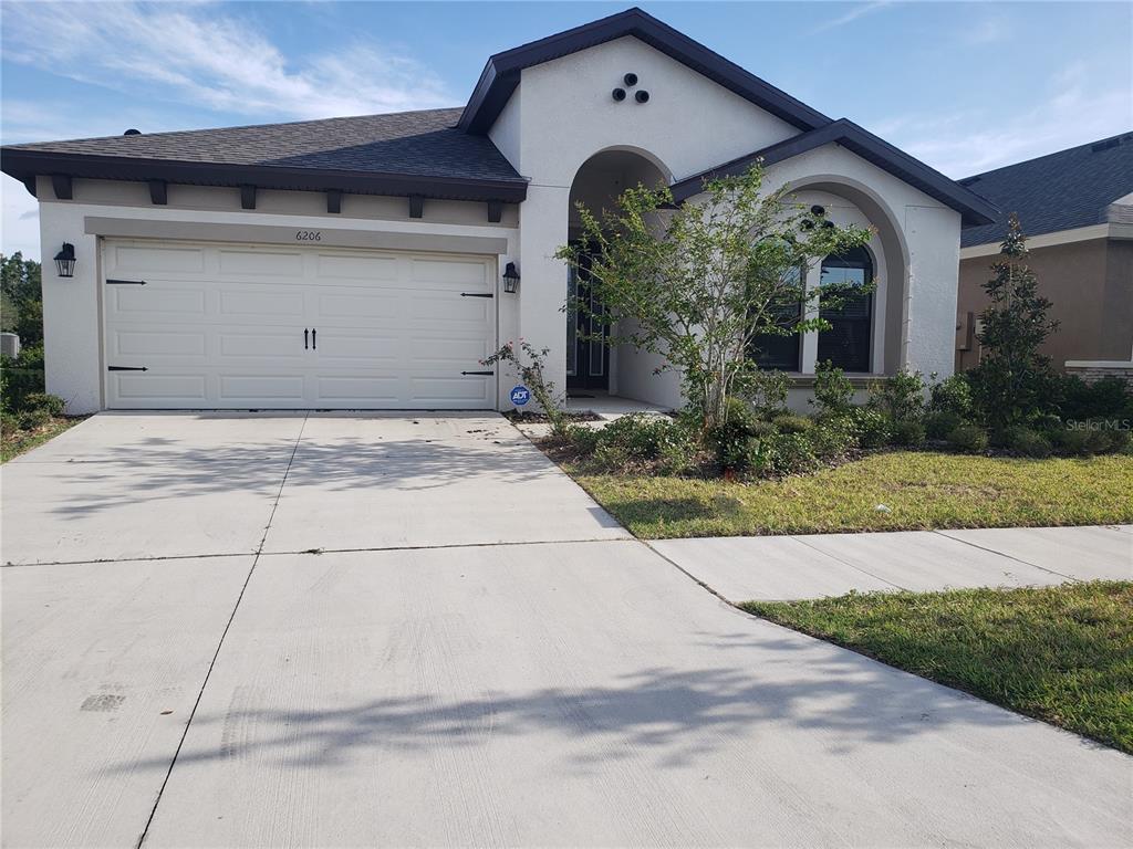 6206 Colmar Place Apollo Beach, FL 33572 - Photo 1 of 26 a front view of a house with garden