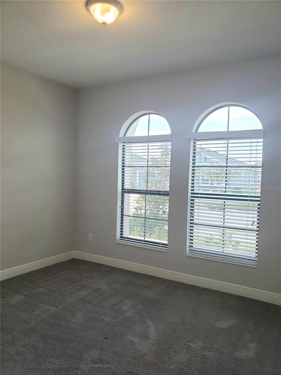 6206 Colmar Place Apollo Beach, FL 33572 - Photo 15 of 26 an empty room with windows and mirror