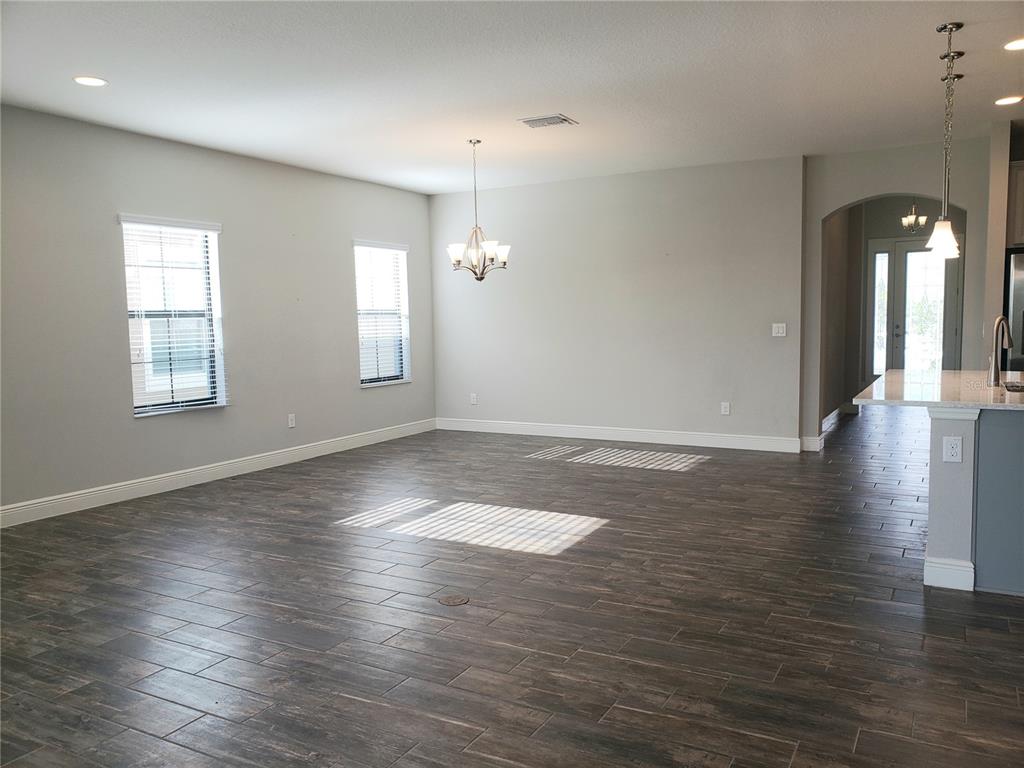 6206 Colmar Place Apollo Beach, FL 33572 - Photo 22 of 26 an empty room with wooden floor and windows