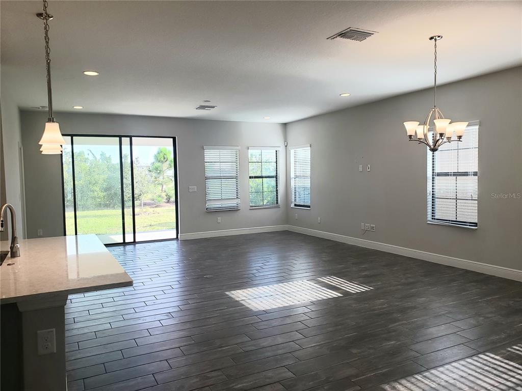 6206 Colmar Place Apollo Beach, FL 33572 - Photo 24 of 26 an empty room with wooden floor and windows