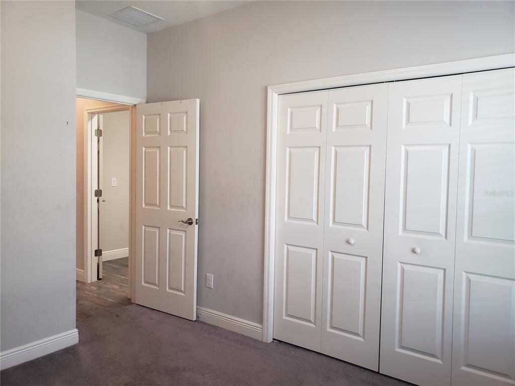 6206 Colmar Place Apollo Beach, FL 33572 - Photo 6 of 26 an empty room with a wooden door