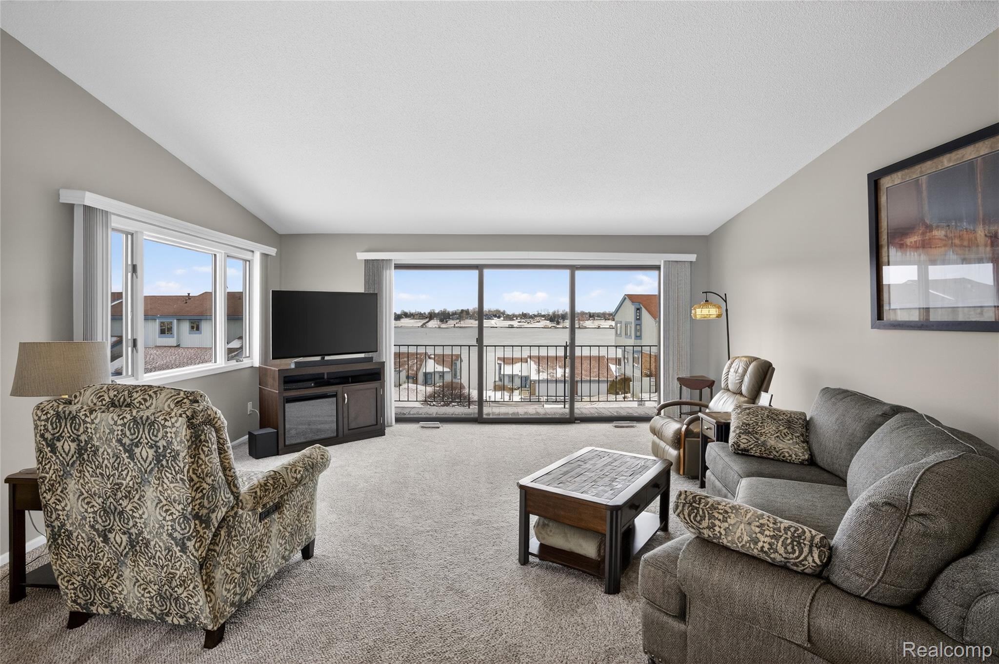 1715 River Road, Unit 77 St. Clair, MI 48079 - Photo 1 of 59 Carpeted living area featuring lofted ceiling and healthy amount of natural light