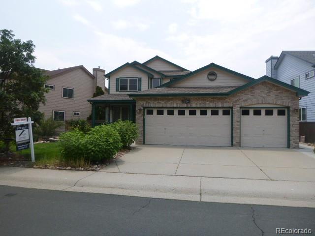 9875 Spring Hill Street Highlands Ranch, CO 80129 - Photo 2 of 38 a front view of a house with a garden and plants