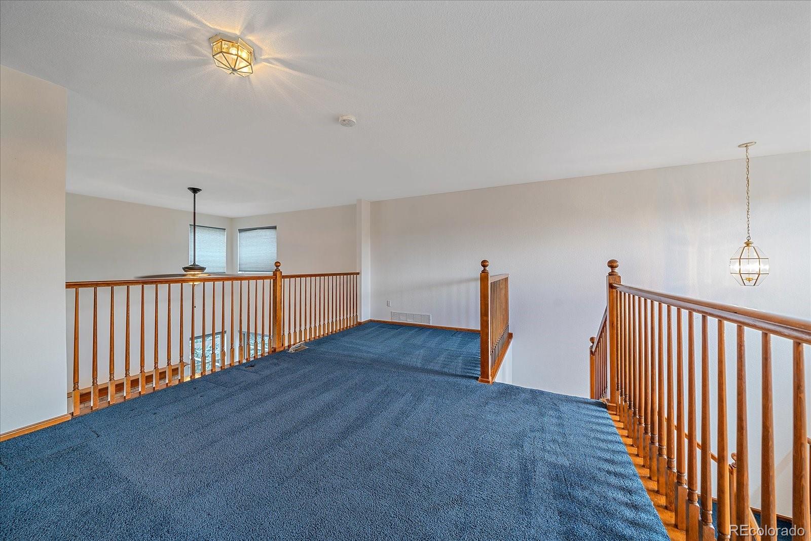 9875 Spring Hill Street Highlands Ranch, CO 80129 - Photo 23 of 38 a view of a hallway with wooden floor