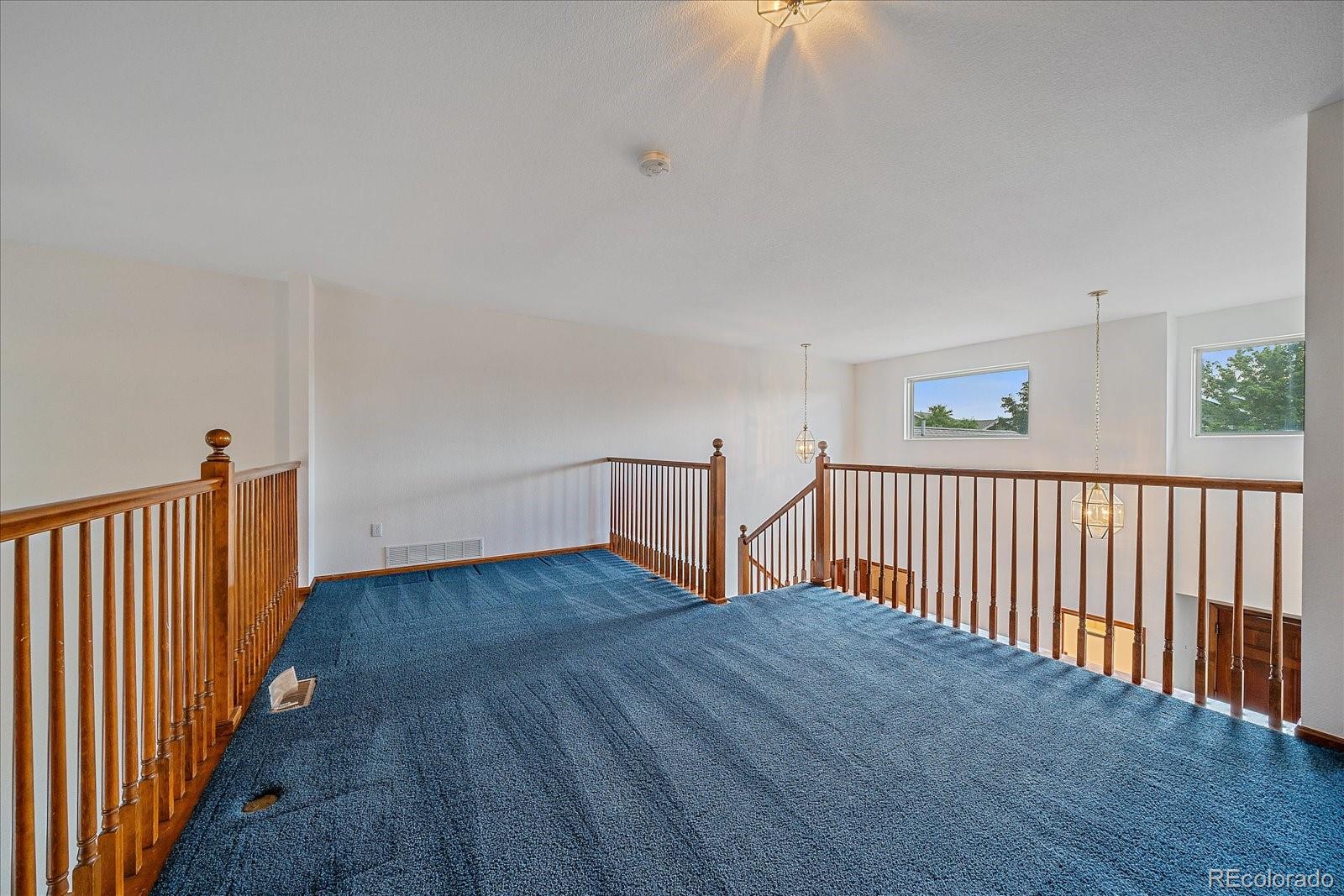 9875 Spring Hill Street Highlands Ranch, CO 80129 - Photo 25 of 38 a view of a hallway with wooden floor