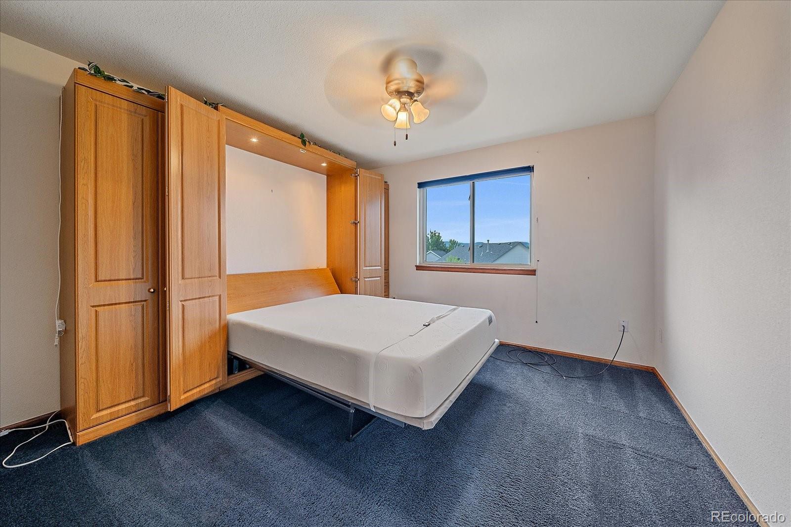 9875 Spring Hill Street Highlands Ranch, CO 80129 - Photo 28 of 38 a bedroom with a bed and a window