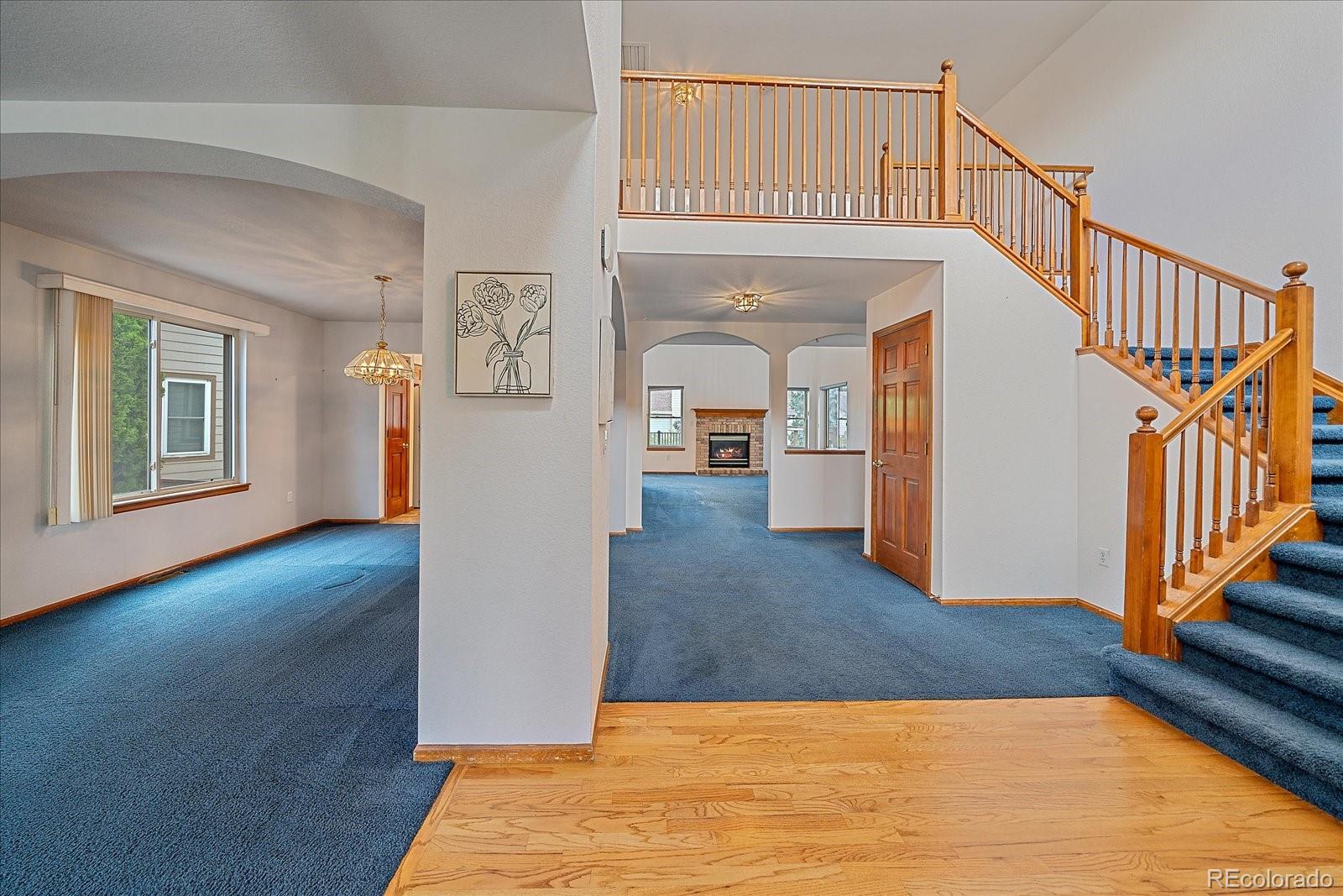 9875 Spring Hill Street Highlands Ranch, CO 80129 - Photo 3 of 38 a view of a livingroom with wooden floor and stairs