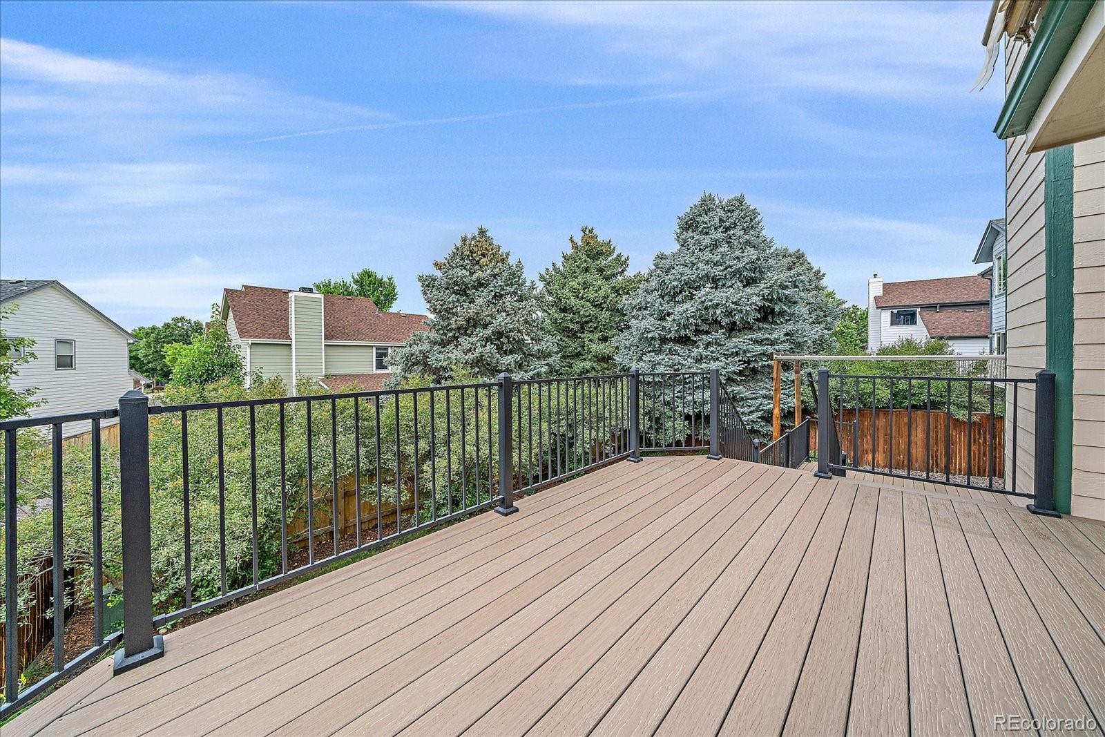 9875 Spring Hill Street Highlands Ranch, CO 80129 - Photo 31 of 38 a balcony with wooden floor and city view