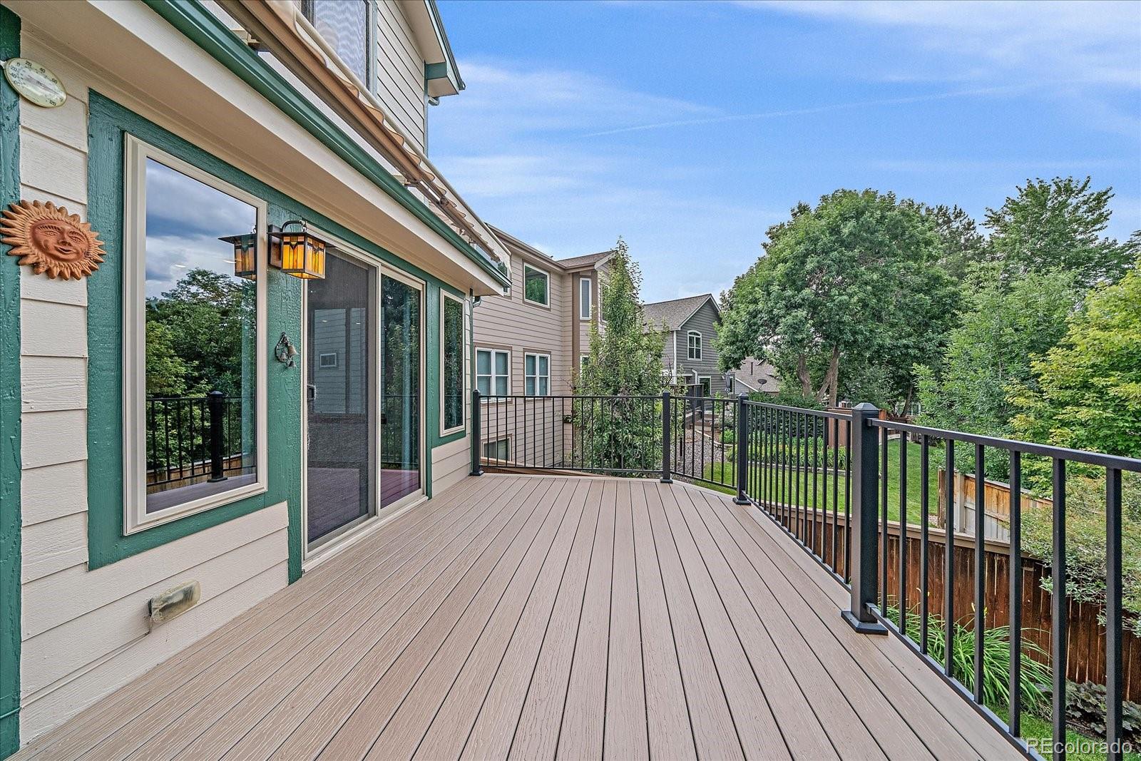 9875 Spring Hill Street Highlands Ranch, CO 80129 - Photo 32 of 38 a balcony with wooden floor and fence