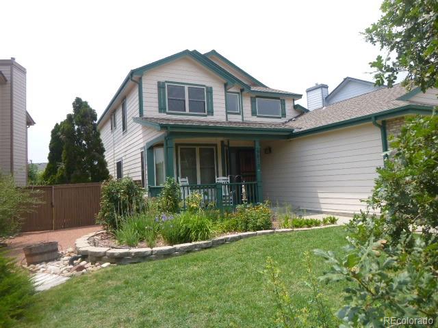 9875 Spring Hill Street Highlands Ranch, CO 80129 - Photo 37 of 38 a front view of a house with a yard