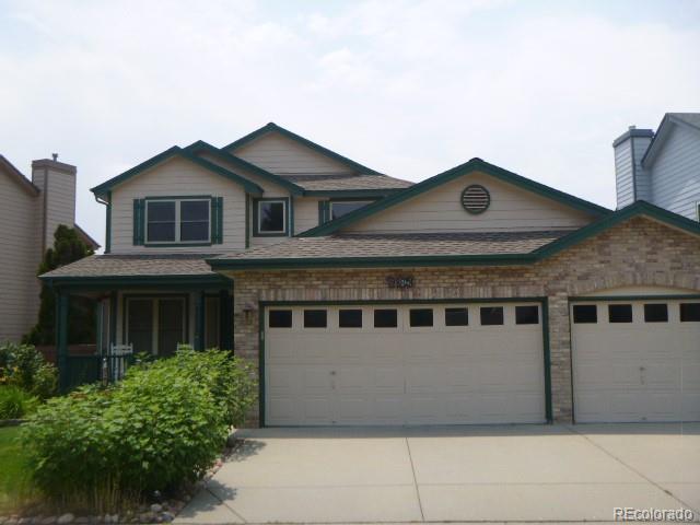 9875 Spring Hill Street Highlands Ranch, CO 80129 - Photo 38 of 38 a front view of a house with a yard and garage