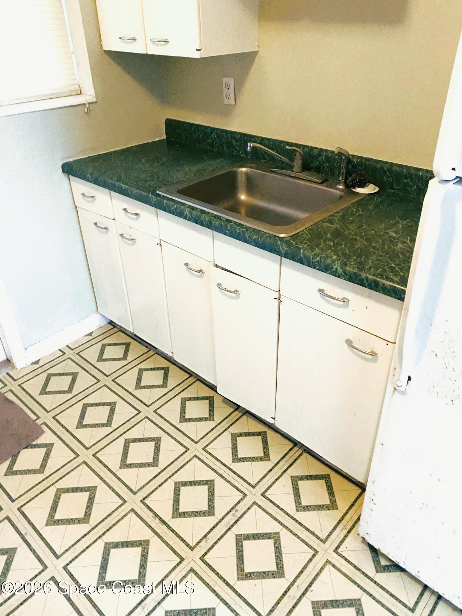 1199 Jordan Court Northeast, Unit B Palm Bay, FL 32905 - Photo 11 of 20 a kitchen with a sink and cabinets