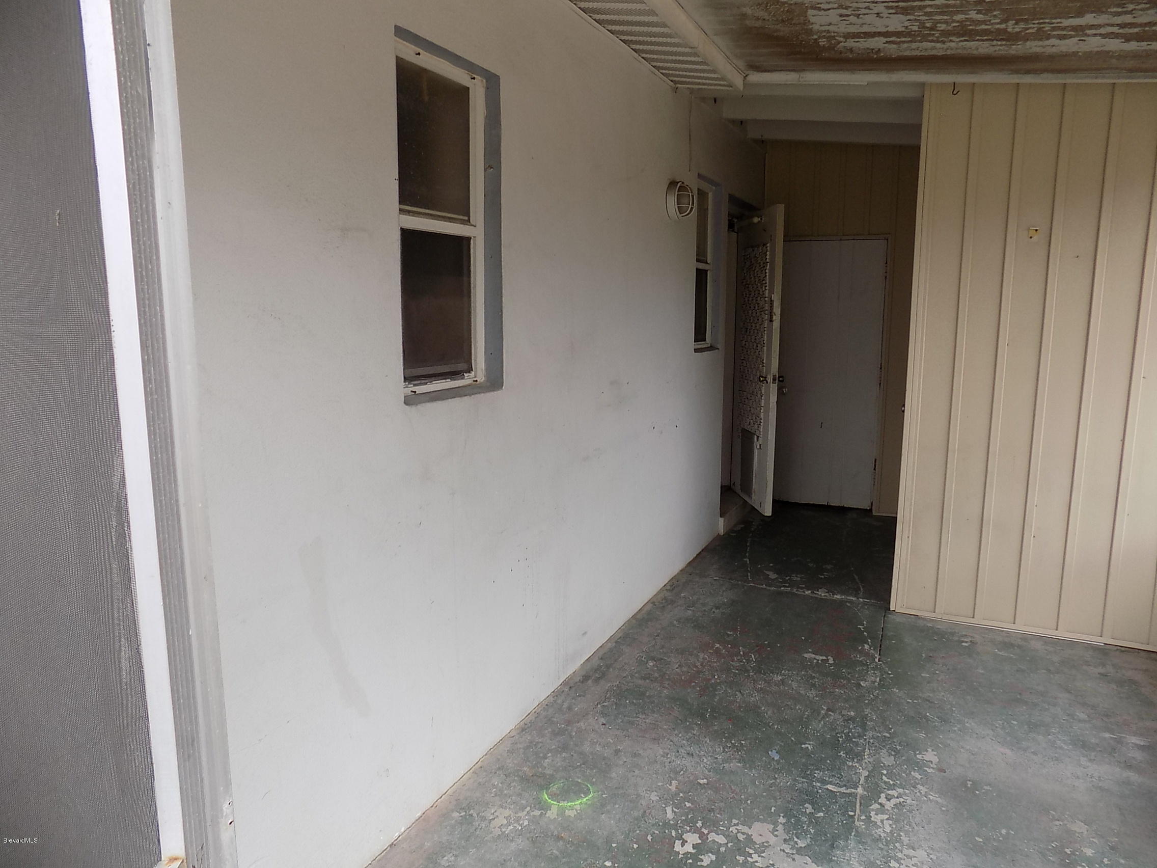 1199 Jordan Court Northeast, Unit B Palm Bay, FL 32905 - Photo 14 of 20 a view of a hallway with wooden shelves