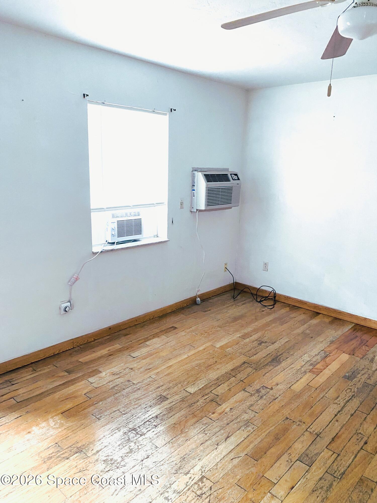 1199 Jordan Court Northeast, Unit B Palm Bay, FL 32905 - Photo 2 of 20 a view of empty room with wooden floor and fan