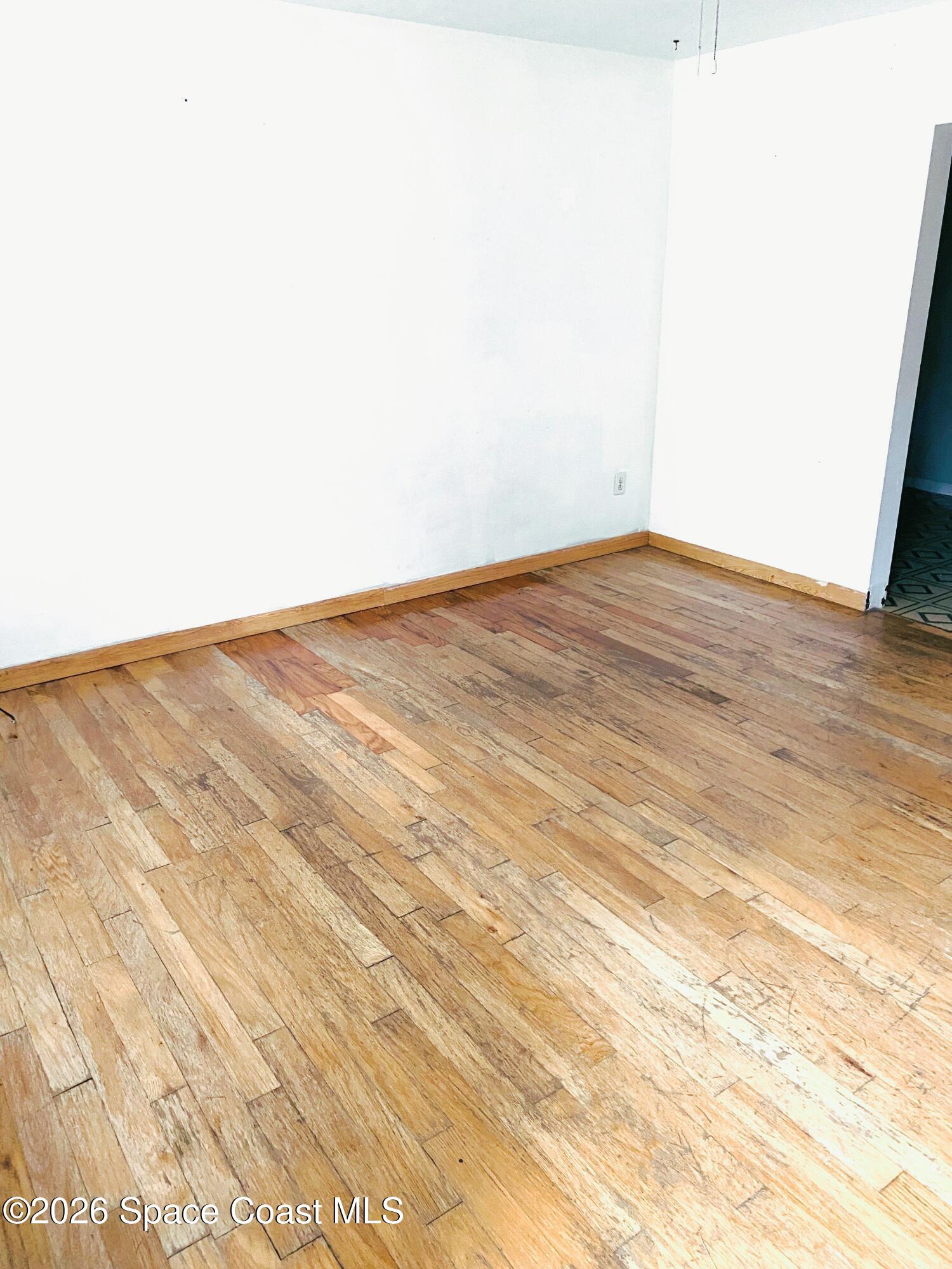 1199 Jordan Court Northeast, Unit B Palm Bay, FL 32905 - Photo 3 of 20 a view of empty room with wooden floor
