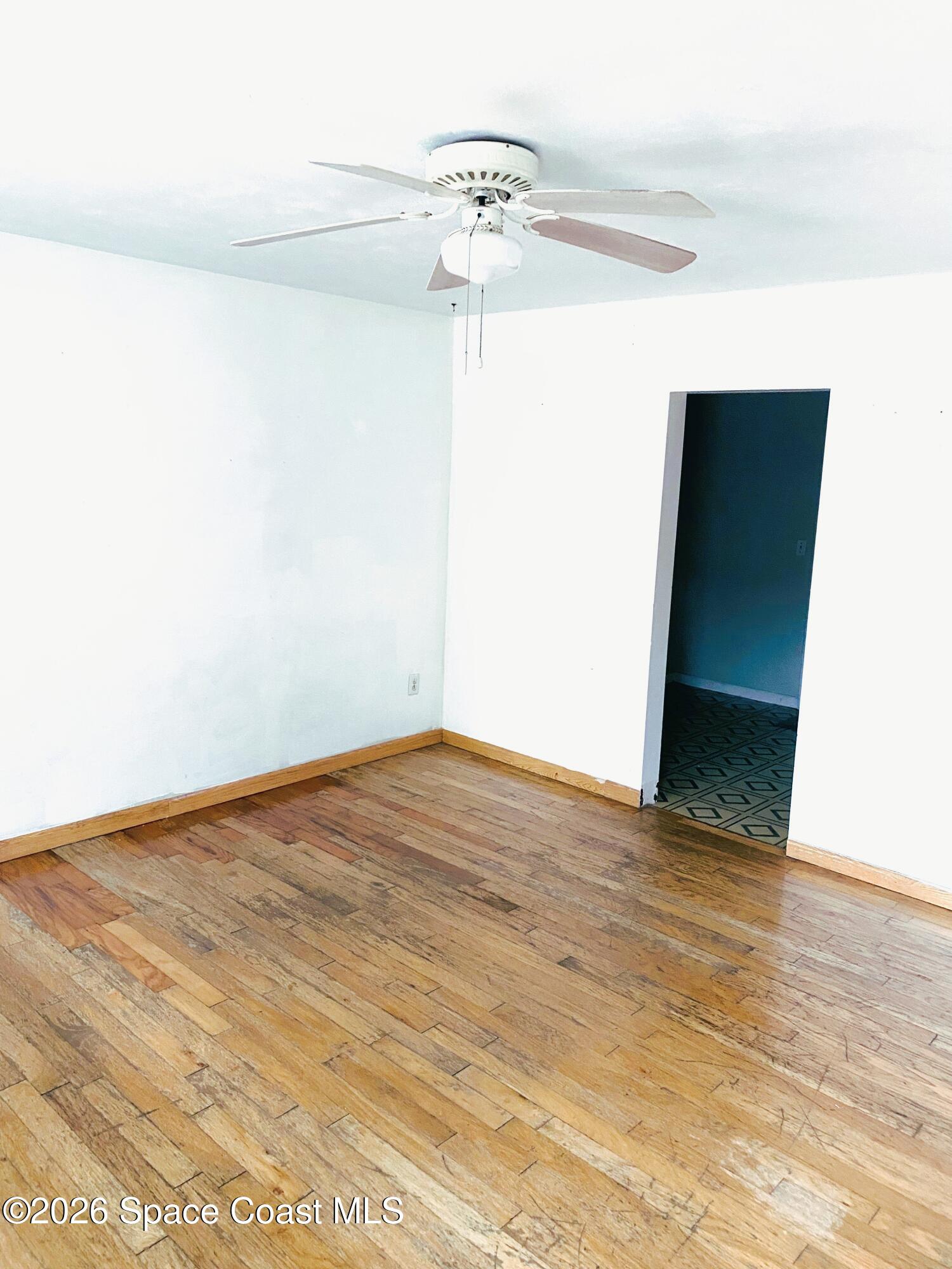 1199 Jordan Court Northeast, Unit B Palm Bay, FL 32905 - Photo 4 of 20 a view of empty room with wooden floor