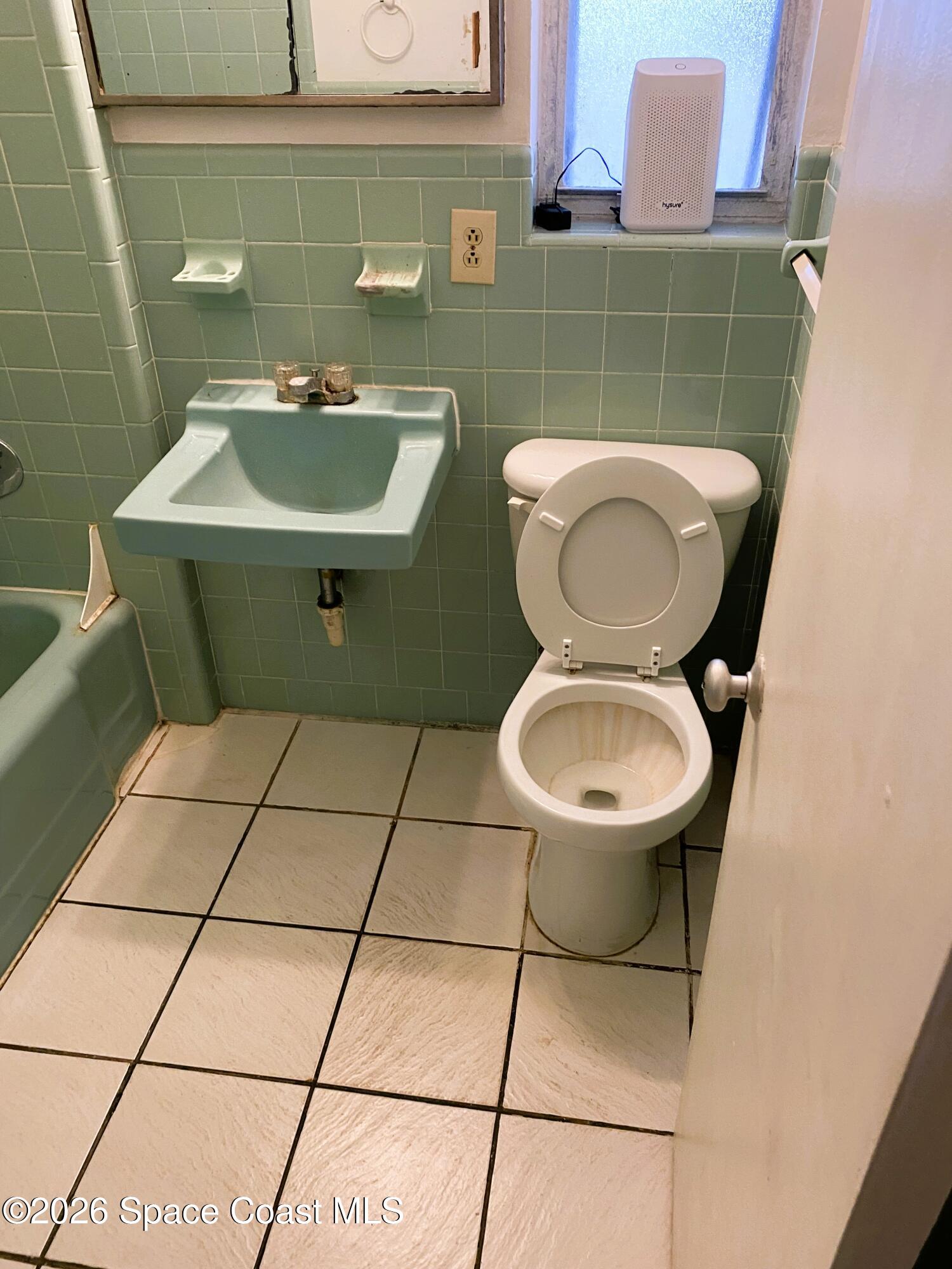 1199 Jordan Court Northeast, Unit B Palm Bay, FL 32905 - Photo 10 of 20 a bathroom with a sink toilet and a mirror