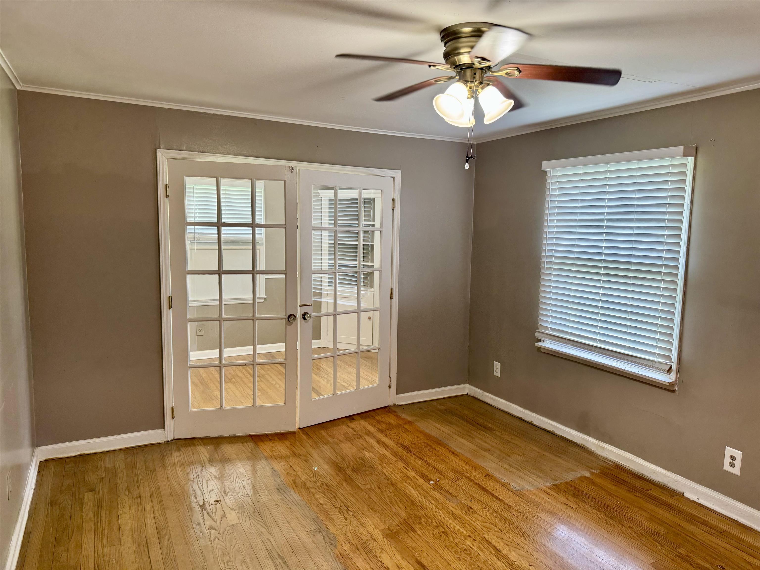 3787 Rhodes Avenue Memphis, TN 38111 - Photo 6 of 23 Family room with a ceiling fan, wood flooring, crown molding, and french doors