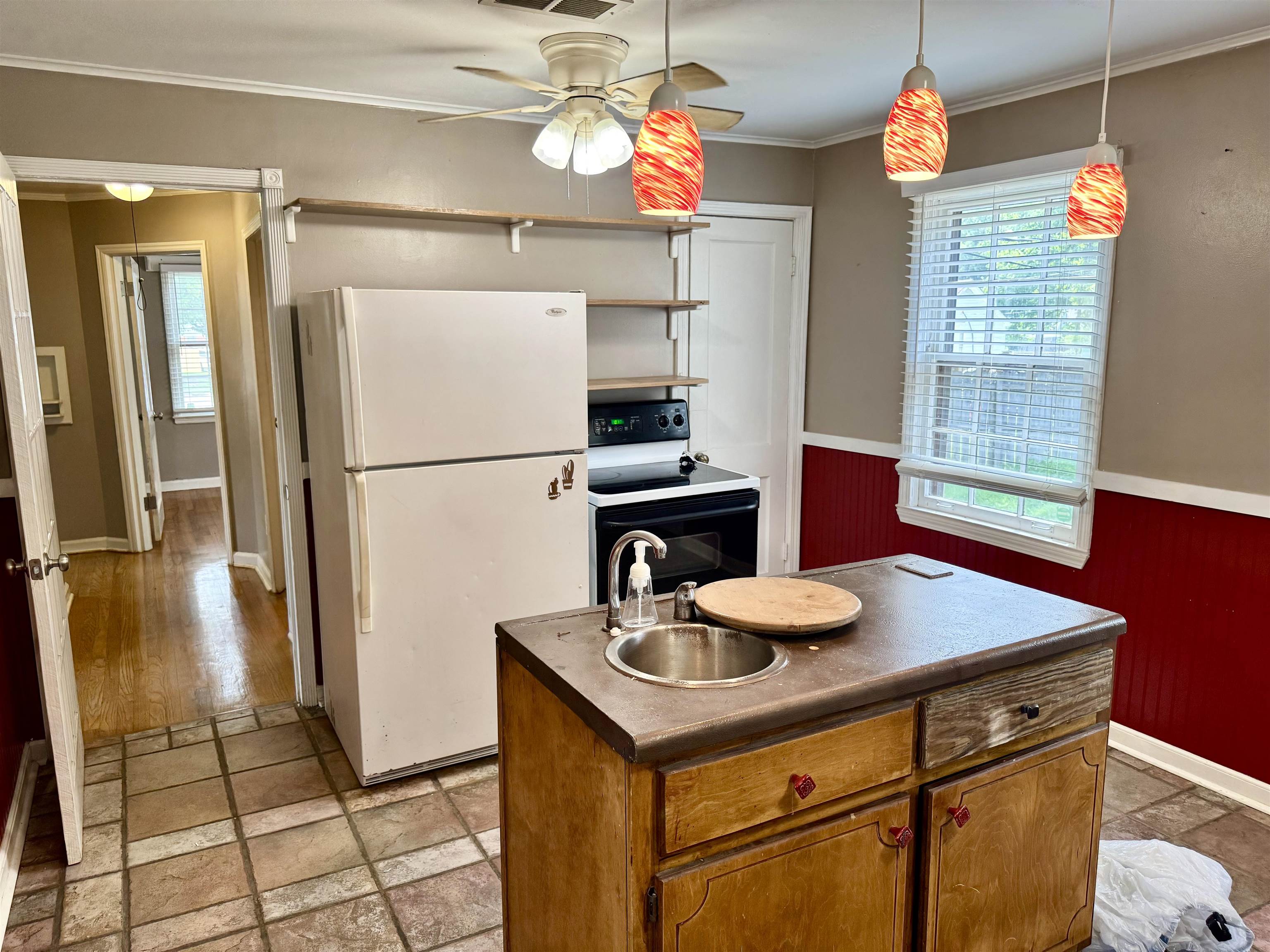 3787 Rhodes Avenue Memphis, TN 38111 - Photo 10 of 23 Kitchen withrefrigerator, range with electric cooktop, a ceiling fan, Prep sink in Island dark countertops, and crown molding