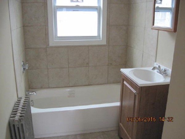 3 Prentice Avenue Auburn, MA 01501 - Photo 3 of 6 a bathroom with a sink a bathtub and a window