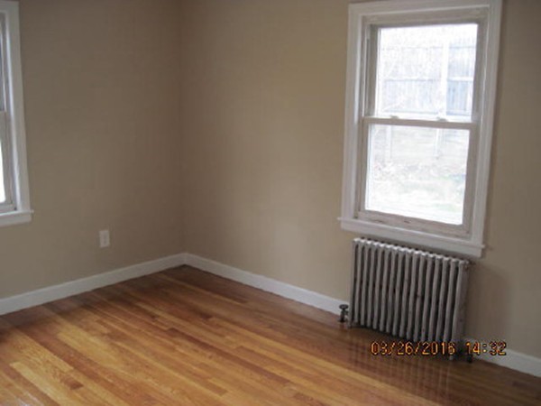 3 Prentice Avenue Auburn, MA 01501 - Photo 4 of 6 an empty room with wooden floor and windows