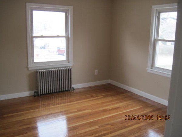 3 Prentice Avenue Auburn, MA 01501 - Photo 5 of 6 an empty room with wooden floor and windows