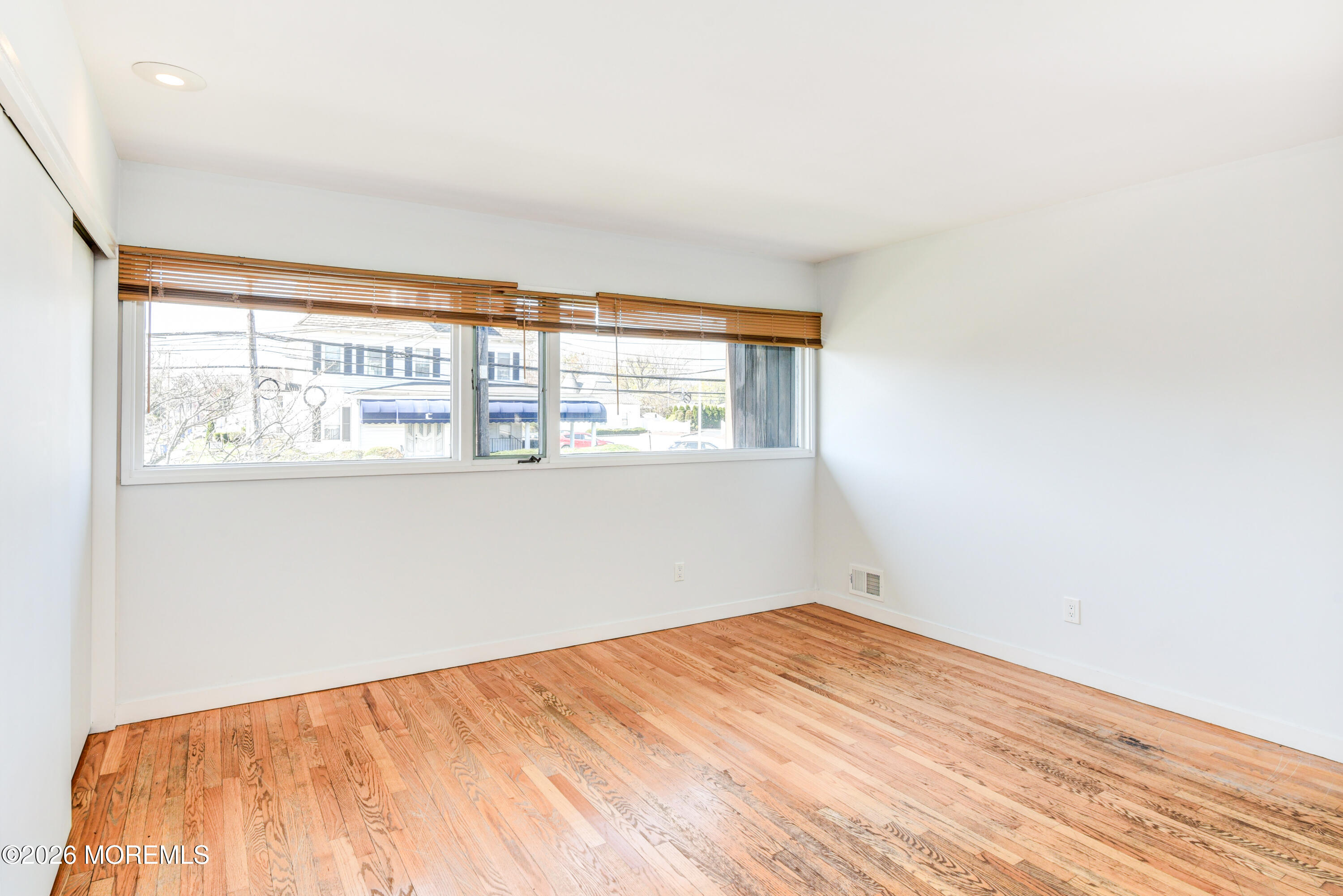 Main Street Milltown, NJ 08850 - Photo 13 of 37 an empty room with wooden floor and windows