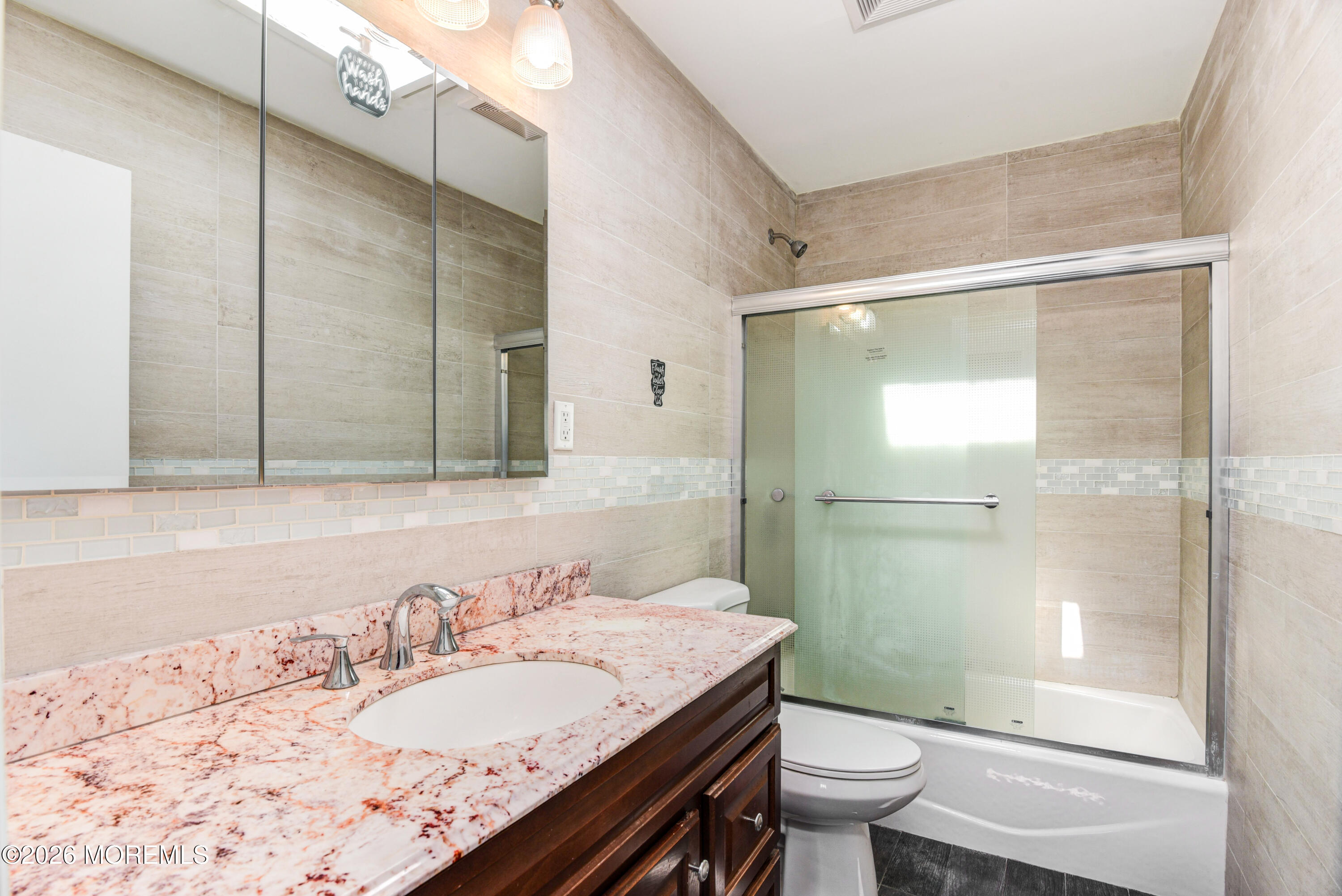 Main Street Milltown, NJ 08850 - Photo 14 of 37 a bathroom with a granite countertop sink a toilet a mirror and shower