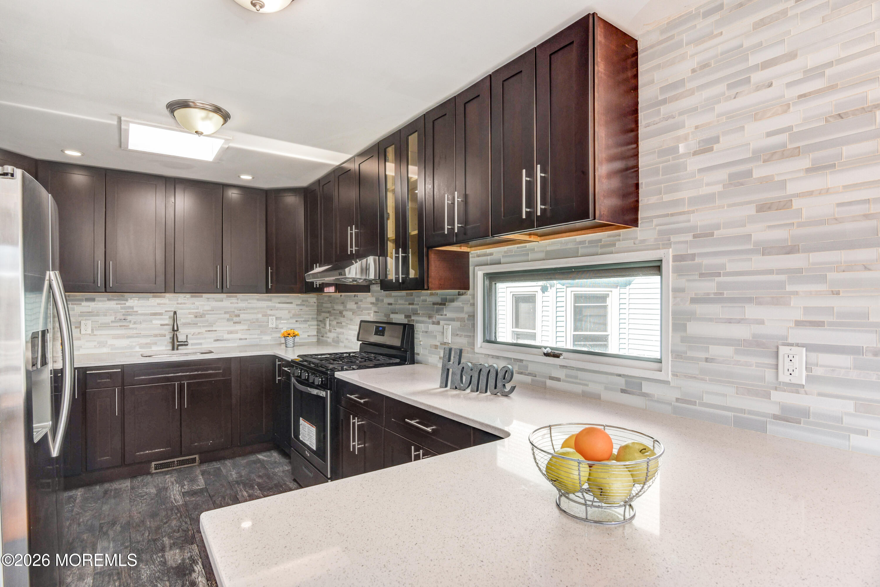 Main Street Milltown, NJ 08850 - Photo 7 of 37 a kitchen with stainless steel appliances granite countertop a sink dishwasher stove and cabinets with wooden floor