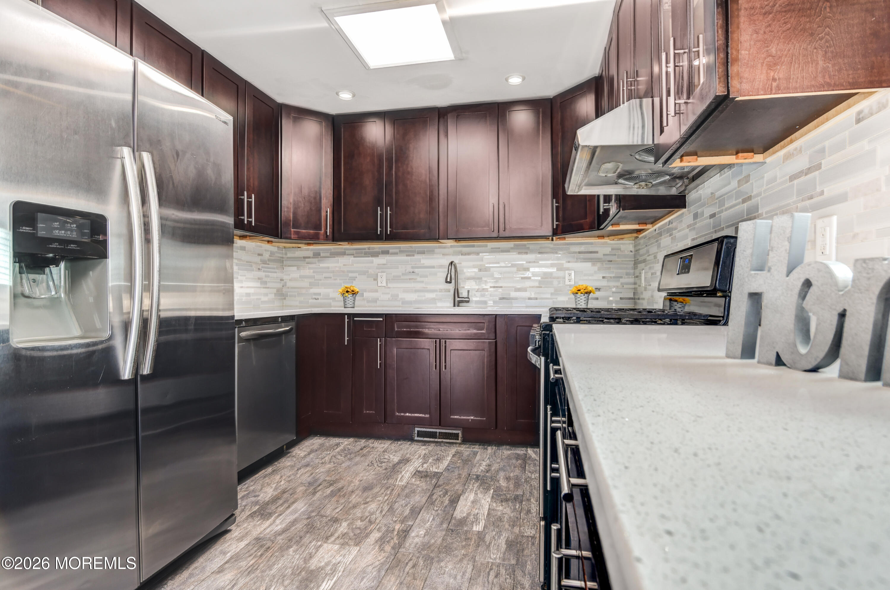 Main Street Milltown, NJ 08850 - Photo 8 of 37 a kitchen with stainless steel appliances granite countertop a sink a stove and a refrigerator