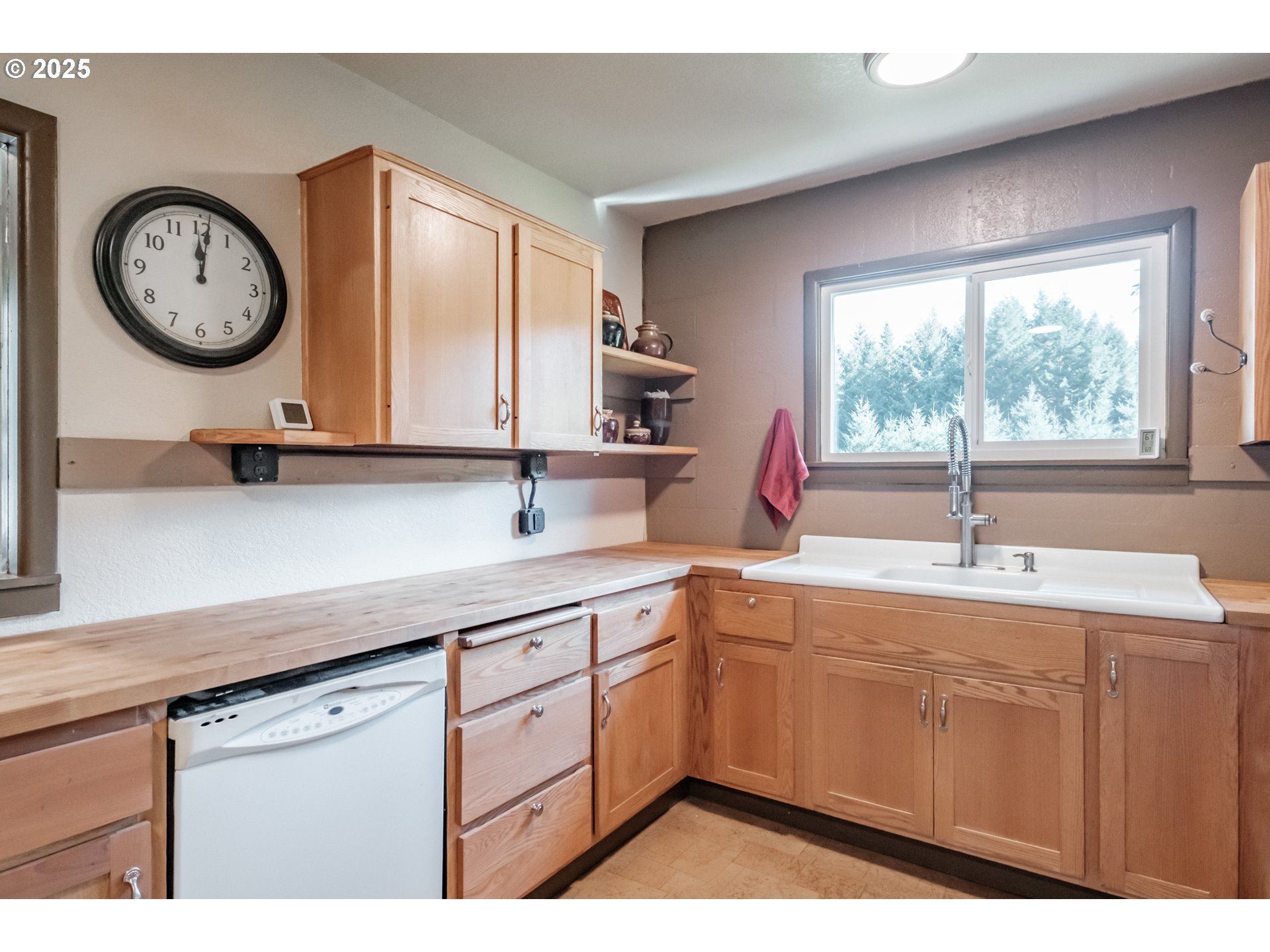9602 Harlan Road Eddyville, OR 97343 - Photo 13 of 48 a kitchen with a large window a sink and a clock on the wall