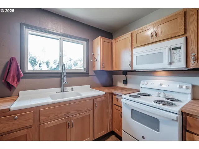 a kitchen with a stove a sink and a microwave