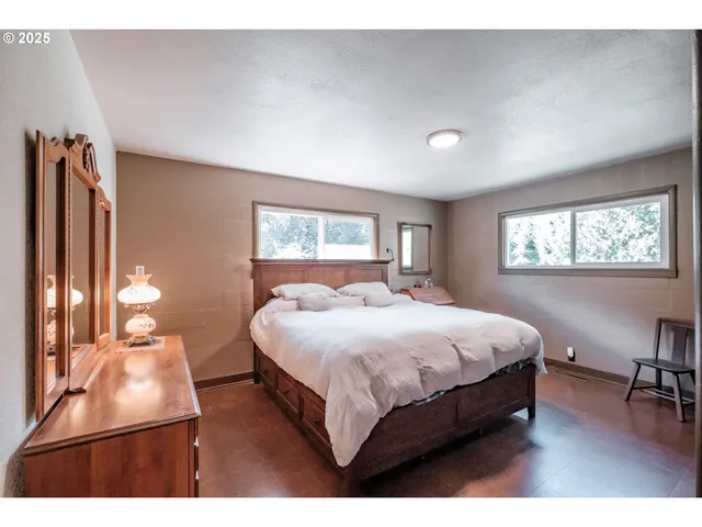 a bedroom with a bed lamps and window