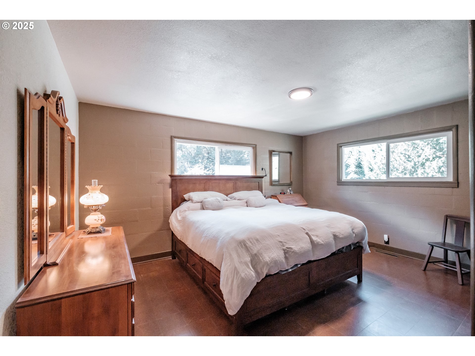 9602 Harlan Road Eddyville, OR 97343 - Photo 16 of 48 a bedroom with a bed lamps and window