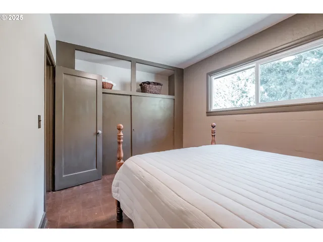 a bedroom with a bed and a dresser