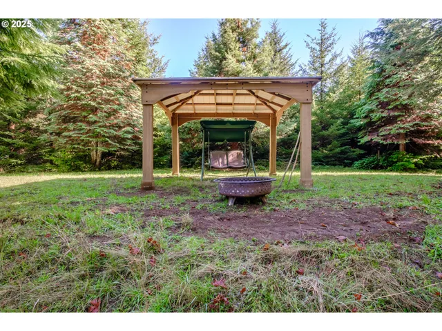 a view of a house with backyard and sitting area